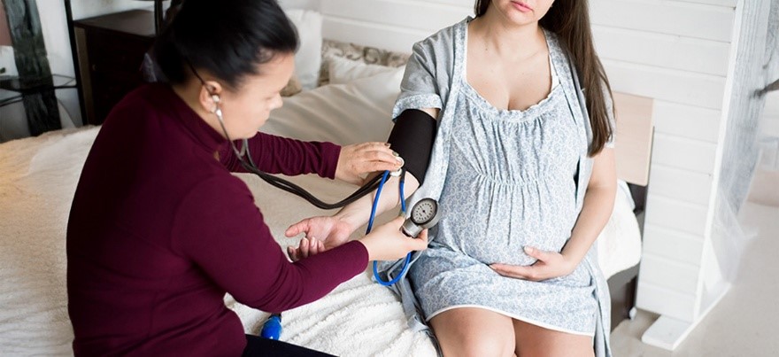 Pregnant woman having blood pressure checked — related to women’s healthcare at BirthRight by Rainbow Hospitals.
